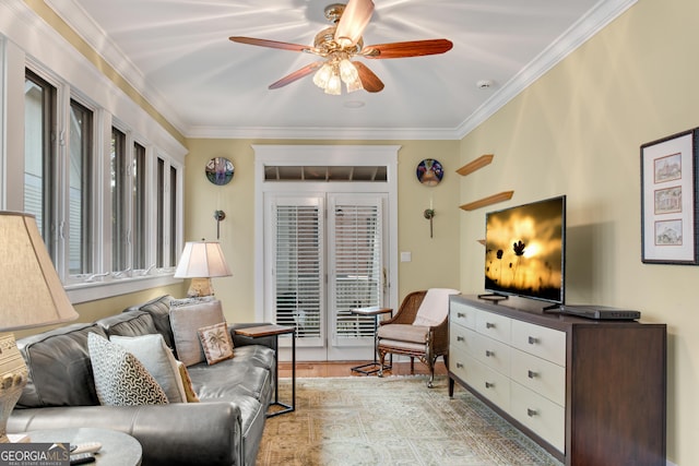 living room featuring crown molding, ceiling fan, and light hardwood / wood-style floors