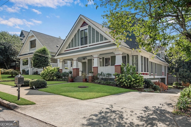 view of front of property with a front yard and covered porch