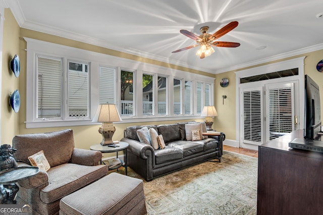 living room with ornamental molding and ceiling fan