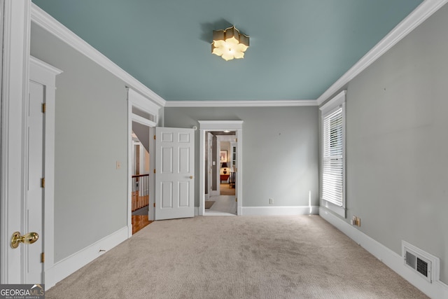 unfurnished bedroom with crown molding and carpet flooring