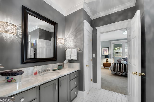 bathroom featuring tile patterned flooring, vanity, and crown molding