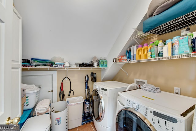 laundry area with washing machine and clothes dryer and light tile patterned floors