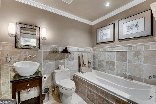 bathroom featuring tile walls, vanity, a relaxing tiled tub, ornamental molding, and toilet