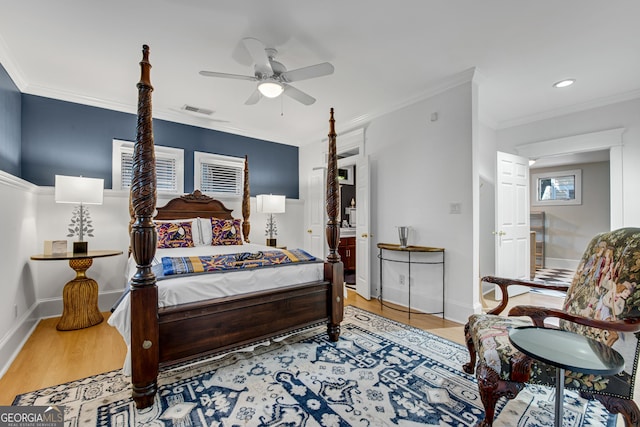 bedroom featuring crown molding, ceiling fan, and light wood-type flooring