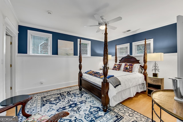 bedroom featuring crown molding, hardwood / wood-style floors, and ceiling fan