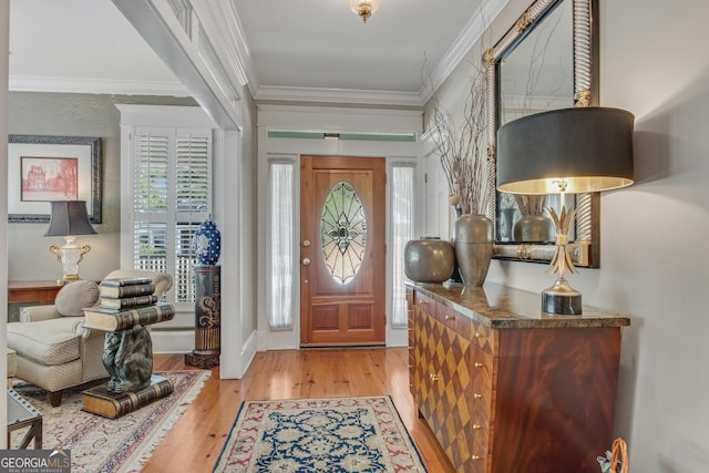 entrance foyer featuring crown molding and light wood-type flooring