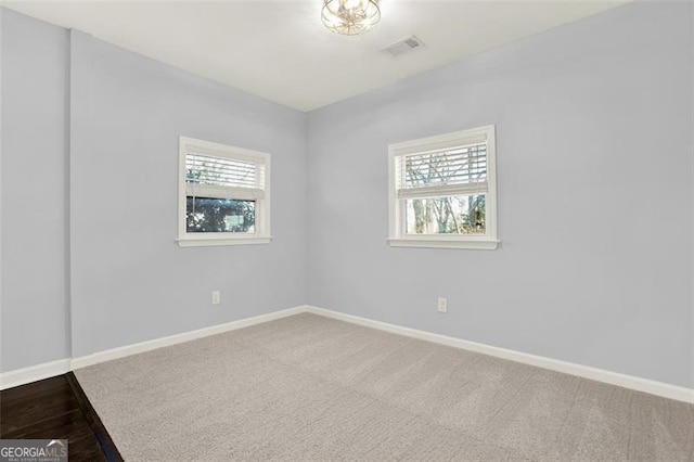 carpeted empty room featuring plenty of natural light