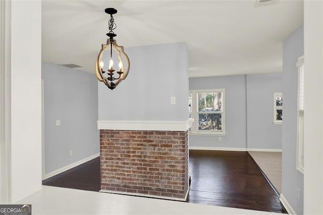 foyer with a chandelier and dark hardwood / wood-style floors