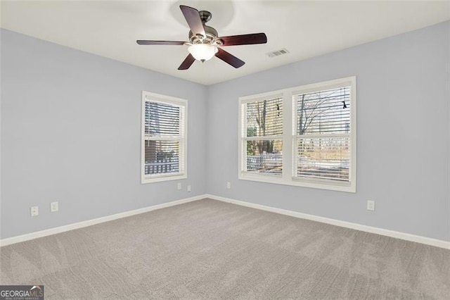 unfurnished room featuring ceiling fan and carpet