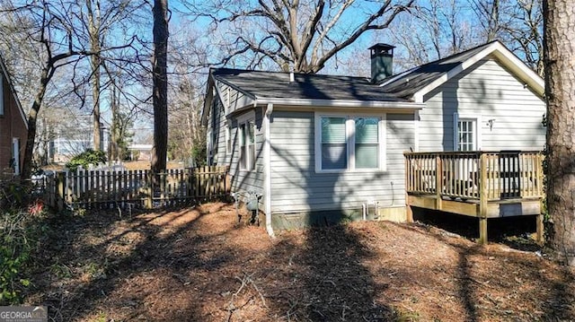 rear view of house featuring a wooden deck