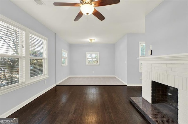 unfurnished living room with a fireplace and dark wood-type flooring