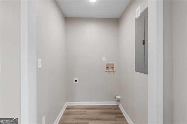 washroom with washer hookup, light hardwood / wood-style flooring, electric dryer hookup, and electric panel