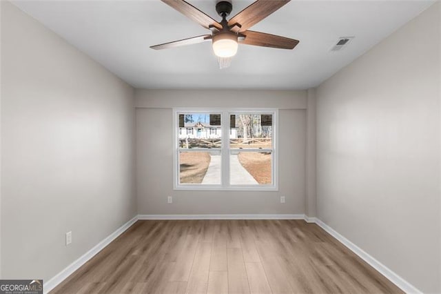 empty room featuring ceiling fan and light hardwood / wood-style flooring