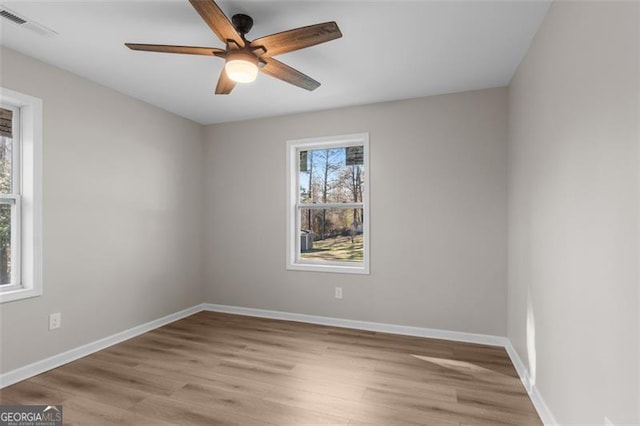 spare room featuring light hardwood / wood-style flooring and ceiling fan