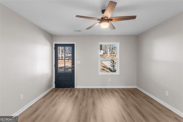 empty room with light wood-type flooring and ceiling fan