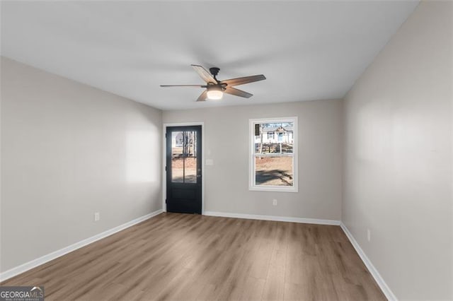 empty room with ceiling fan and hardwood / wood-style floors