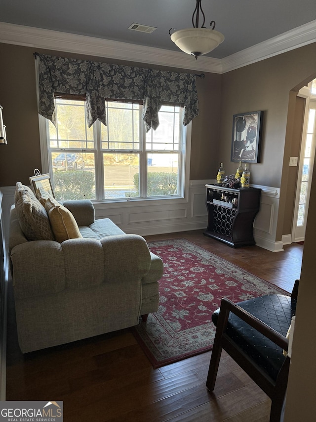 living room with crown molding and wood-type flooring