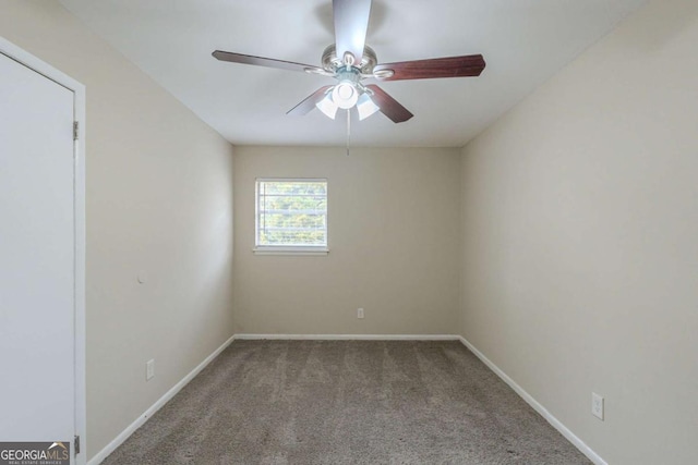 spare room featuring ceiling fan and carpet