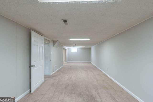 basement with light carpet and a textured ceiling