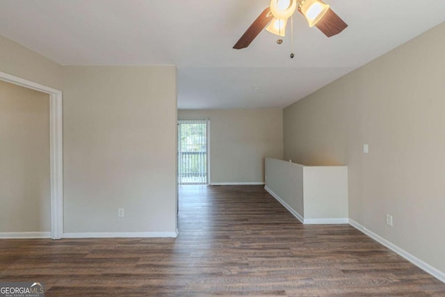 spare room with ceiling fan and dark hardwood / wood-style flooring