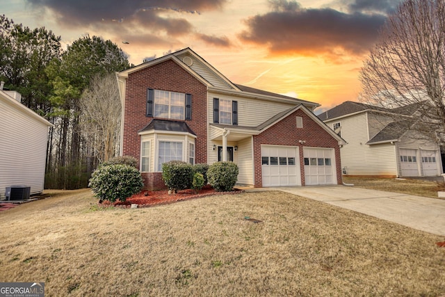 view of front property with central AC, a garage, and a front lawn