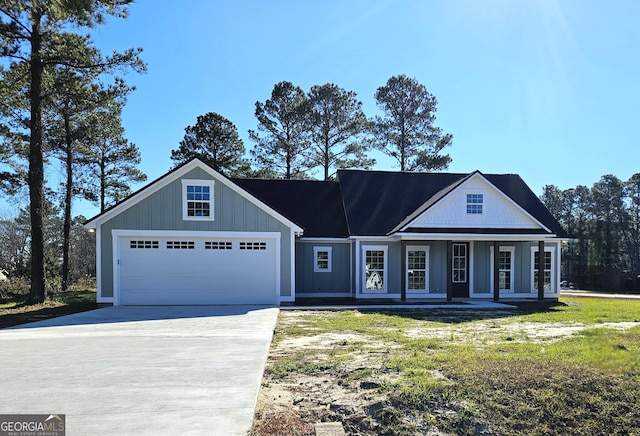 view of front facade with a garage and covered porch