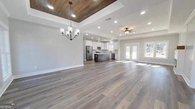 unfurnished living room with a raised ceiling, wooden ceiling, and wood-type flooring