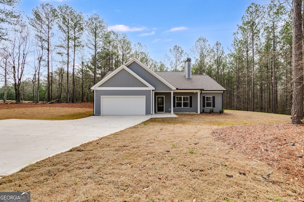 view of front of property featuring a garage and a front lawn