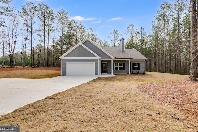 view of front of property featuring a garage and a front lawn