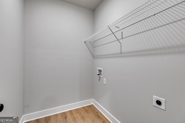 laundry room with hookup for a washing machine, electric dryer hookup, and hardwood / wood-style flooring