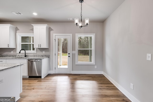 kitchen featuring white cabinetry, dishwasher, sink, light stone counters, and light wood-type flooring