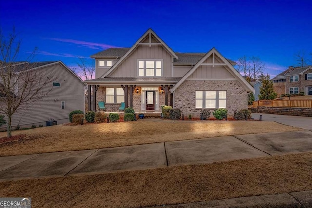 craftsman inspired home with a porch and central AC unit