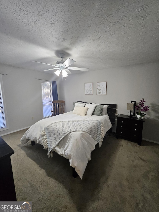 bedroom featuring a textured ceiling, carpet flooring, and a ceiling fan