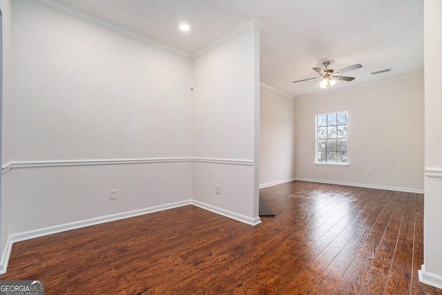 empty room with ceiling fan, ornamental molding, and dark hardwood / wood-style flooring