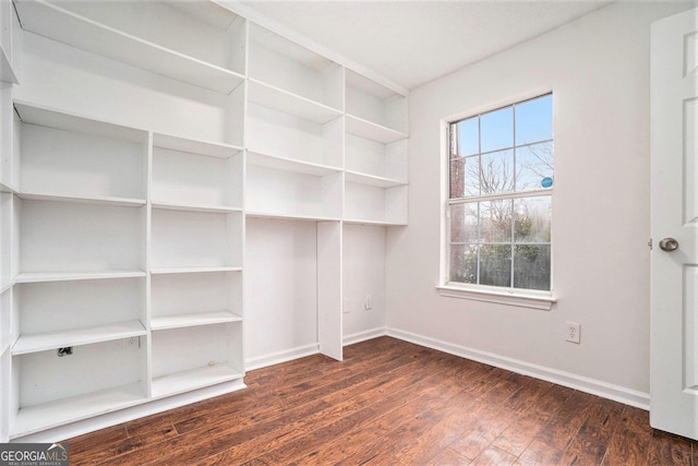 unfurnished room with dark hardwood / wood-style flooring and a healthy amount of sunlight