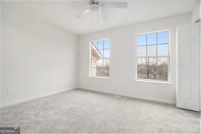 carpeted empty room featuring ceiling fan