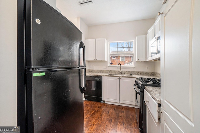 kitchen featuring sink, white cabinets, dark hardwood / wood-style floors, and black appliances