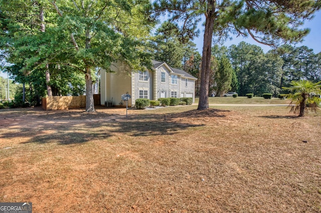 exterior space with central AC and a lawn