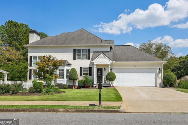 view of front of property with a garage and a front yard