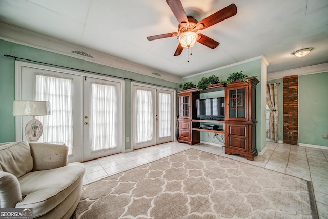 tiled living room featuring ornamental molding, french doors, and ceiling fan