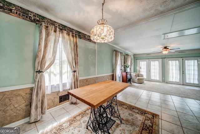 dining room with crown molding, a textured ceiling, french doors, and ceiling fan