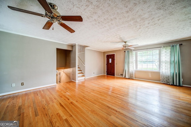 unfurnished living room featuring crown molding, ceiling fan, a textured ceiling, and light hardwood / wood-style flooring