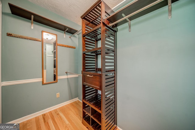 walk in closet featuring hardwood / wood-style flooring