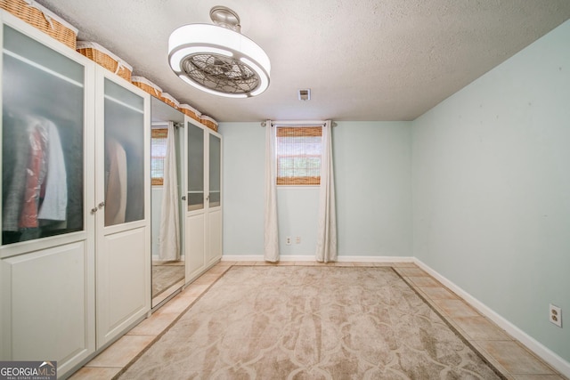 empty room featuring a textured ceiling