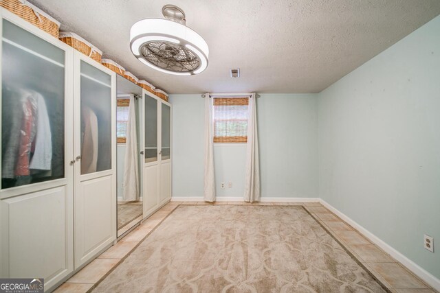 3170 Ebenezer Rd, Marietta, GA 30066 - unfurnished bedroom with a textured ceiling, baseboards, and light tile patterned floors