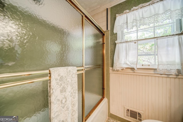 3170 Ebenezer Rd, Marietta, GA 30066 - bathroom featuring crown molding, bath / shower combo with glass door, and a wainscoted wall