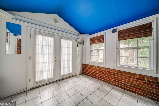 interior space featuring french doors and lofted ceiling