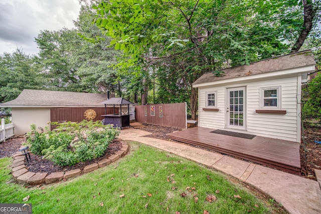 view of yard with a hot tub and a deck