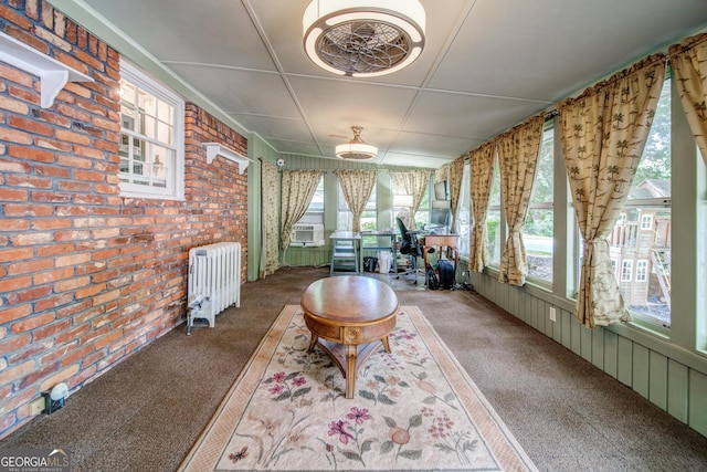 unfurnished sunroom featuring cooling unit and radiator heating unit