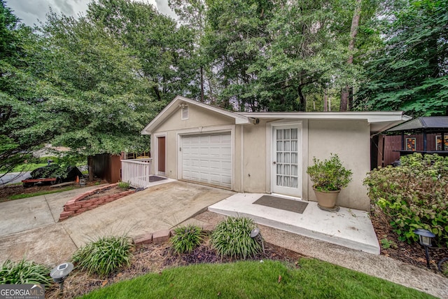 view of front of house featuring a garage and an outdoor structure